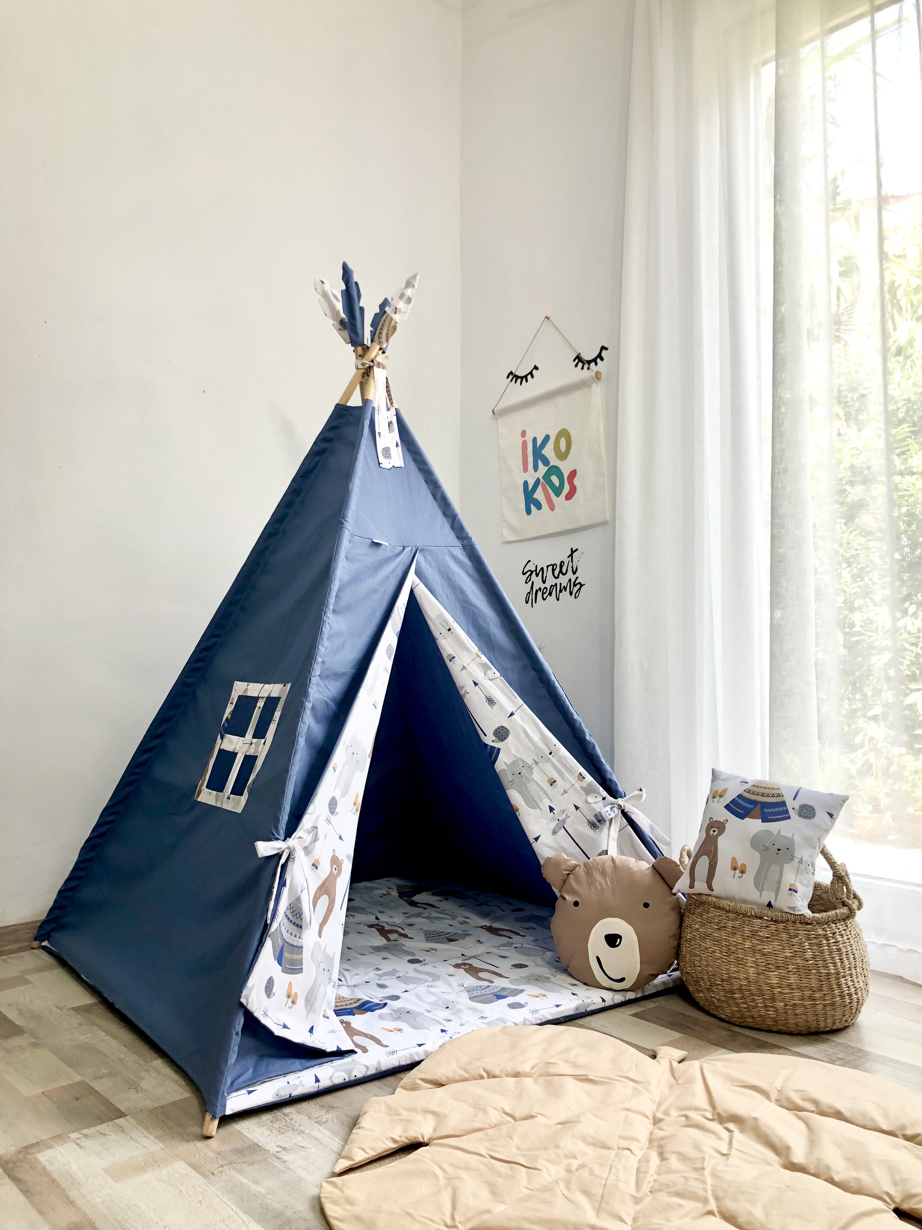 Blue children's tent with teddy bear and square cushions